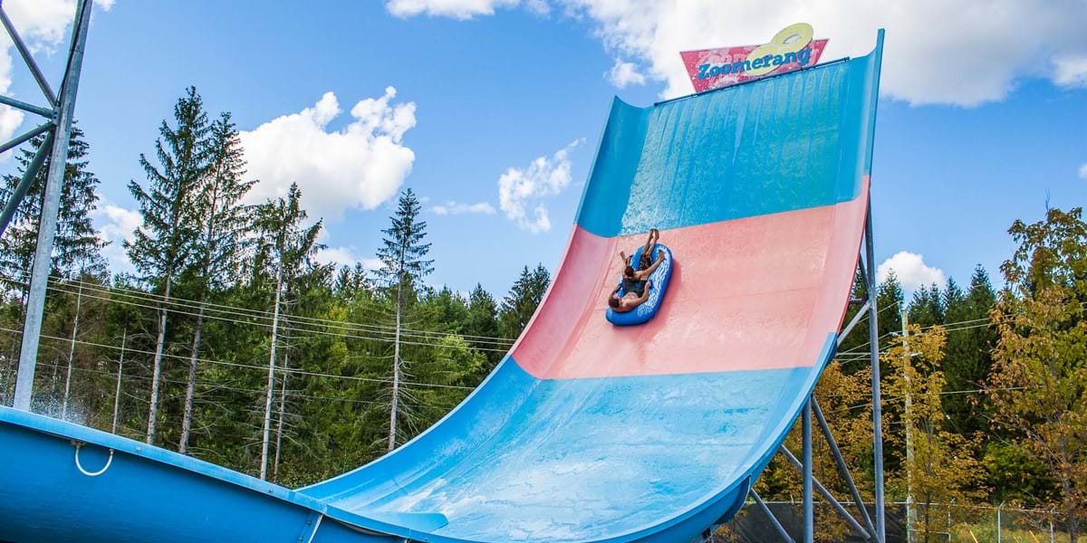 Two guests zooming down Zoomerang water slide